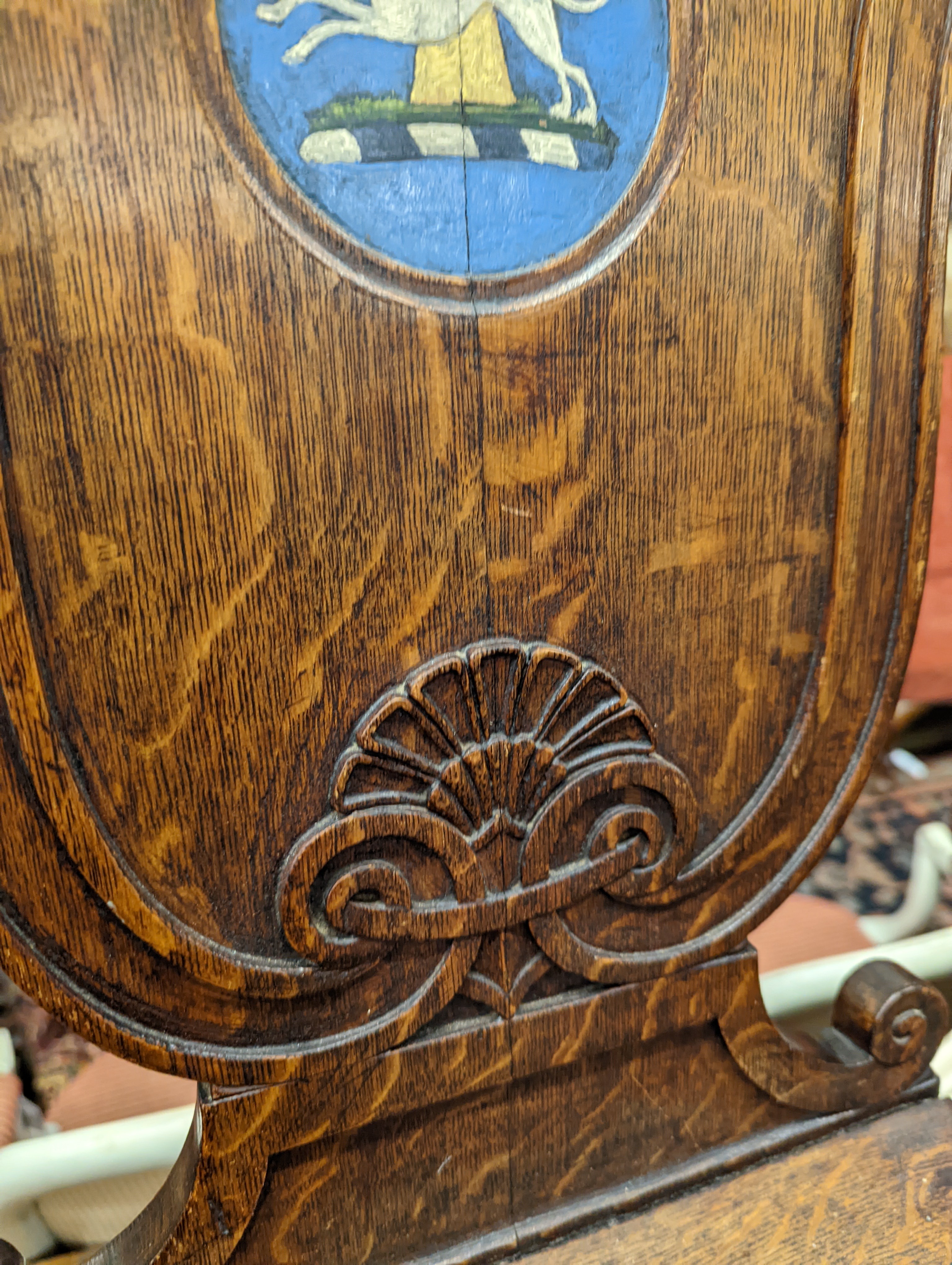 A pair of Victorian oak hall chairs with painted armorials, width 43cm, depth 39cm, height 94cm